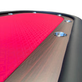 Close-up of a red and black gaming table with a metallic cup holder.